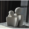Modern sculpture symbolizing connection and tenderness