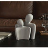 Modern sculpture symbolizing connection and tenderness